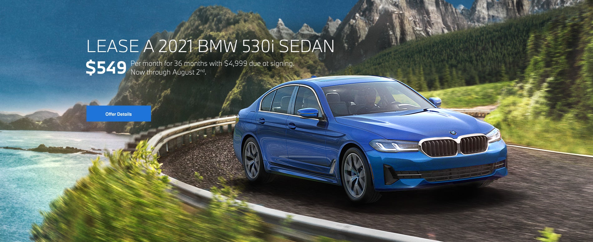 Blue 5 series going around a bend on oceanside highway