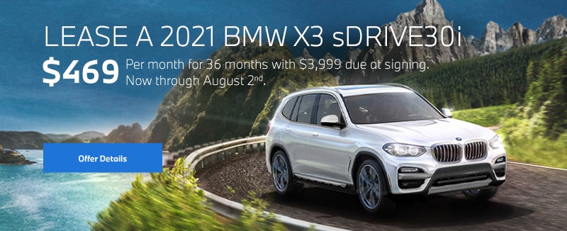 White X3 going around a bend on oceanside highway