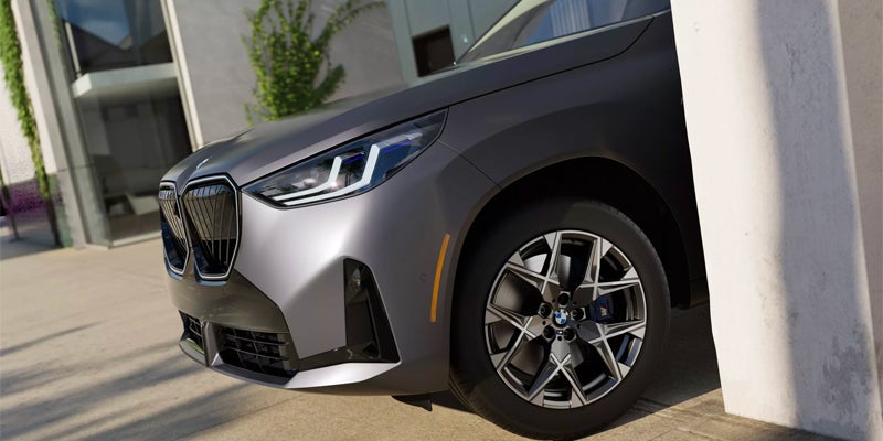 A 2025 BMW X3 exiting a parking garage to power along with its engine on roads in Berkeley, CA