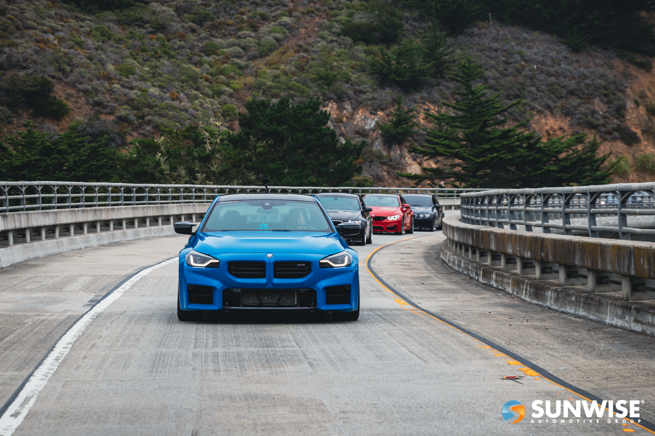 three cars on bridge